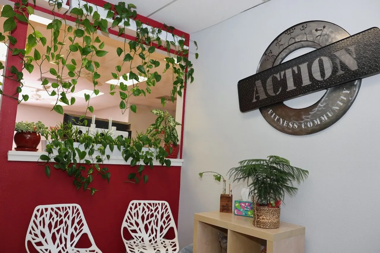 The ACTION sign hanging over the plant-filled lounge by the front window