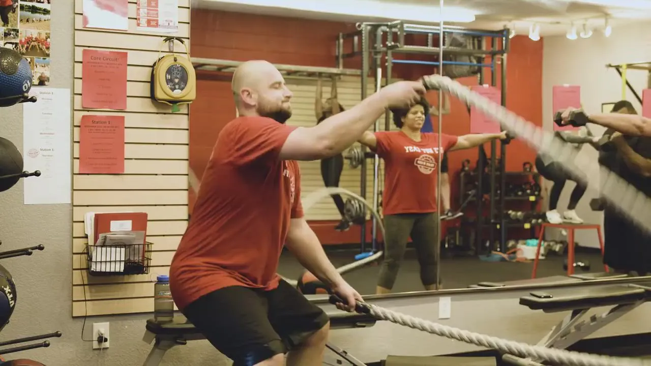 A member working the battle ropes during a class at the studio