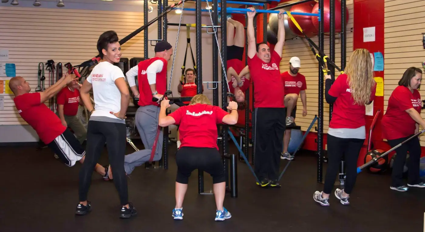 A small group class in red shirts training together at the studio rig