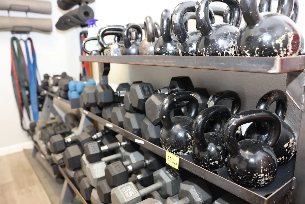 A full rack of dumbbells and kettlebells
