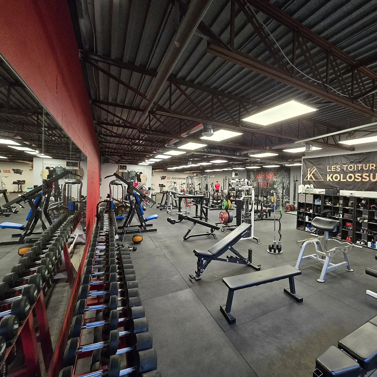 Wide view of the South Shore Iron training floor with dumbbells and benches