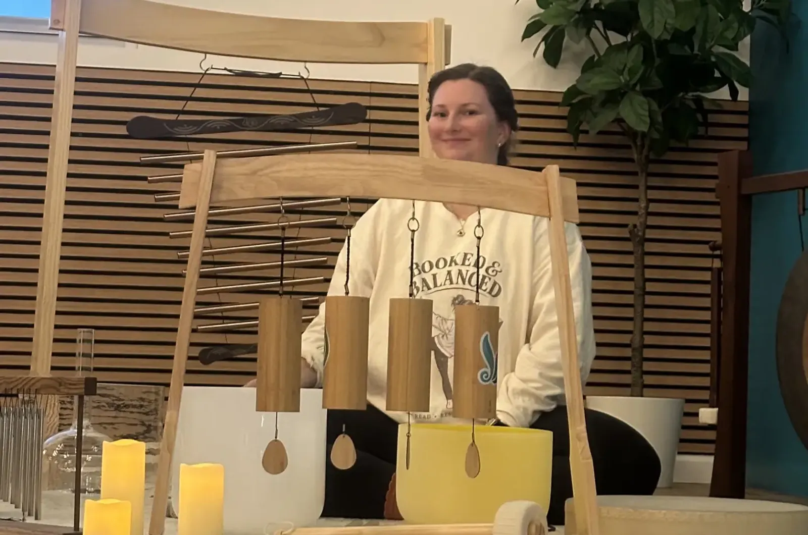 A Teal Yogi teacher with the sound bath chimes and candles