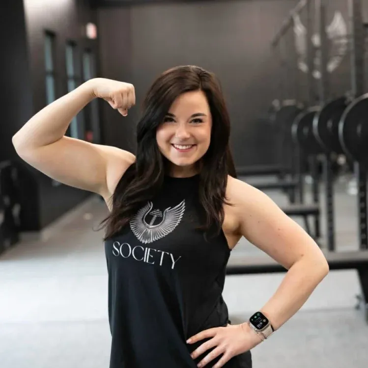 Courtney Reints flexing in the gym