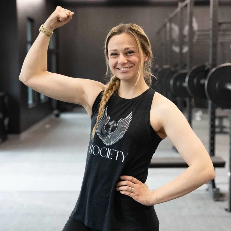 Jillian Johannsen flexing, her hair in a braid